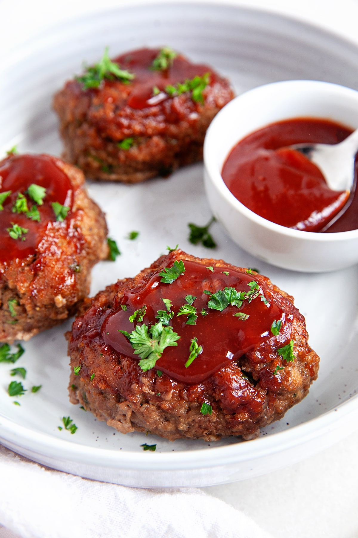 Mini meatloaf close-up with extra sauce on top. 