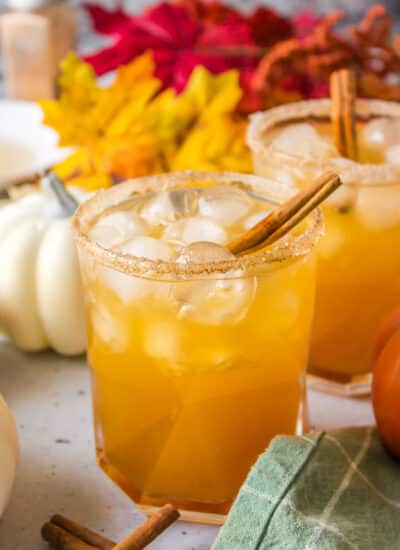 Pumpkin Spice Cocktails with fall foliage and pumpkins.