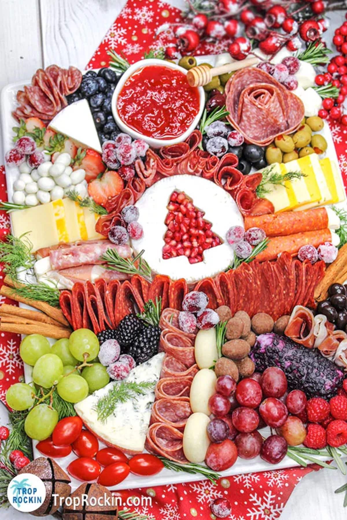 Christmas Charcuterie Board with meats, cheese, fruit, vegetables, olives and jam. 