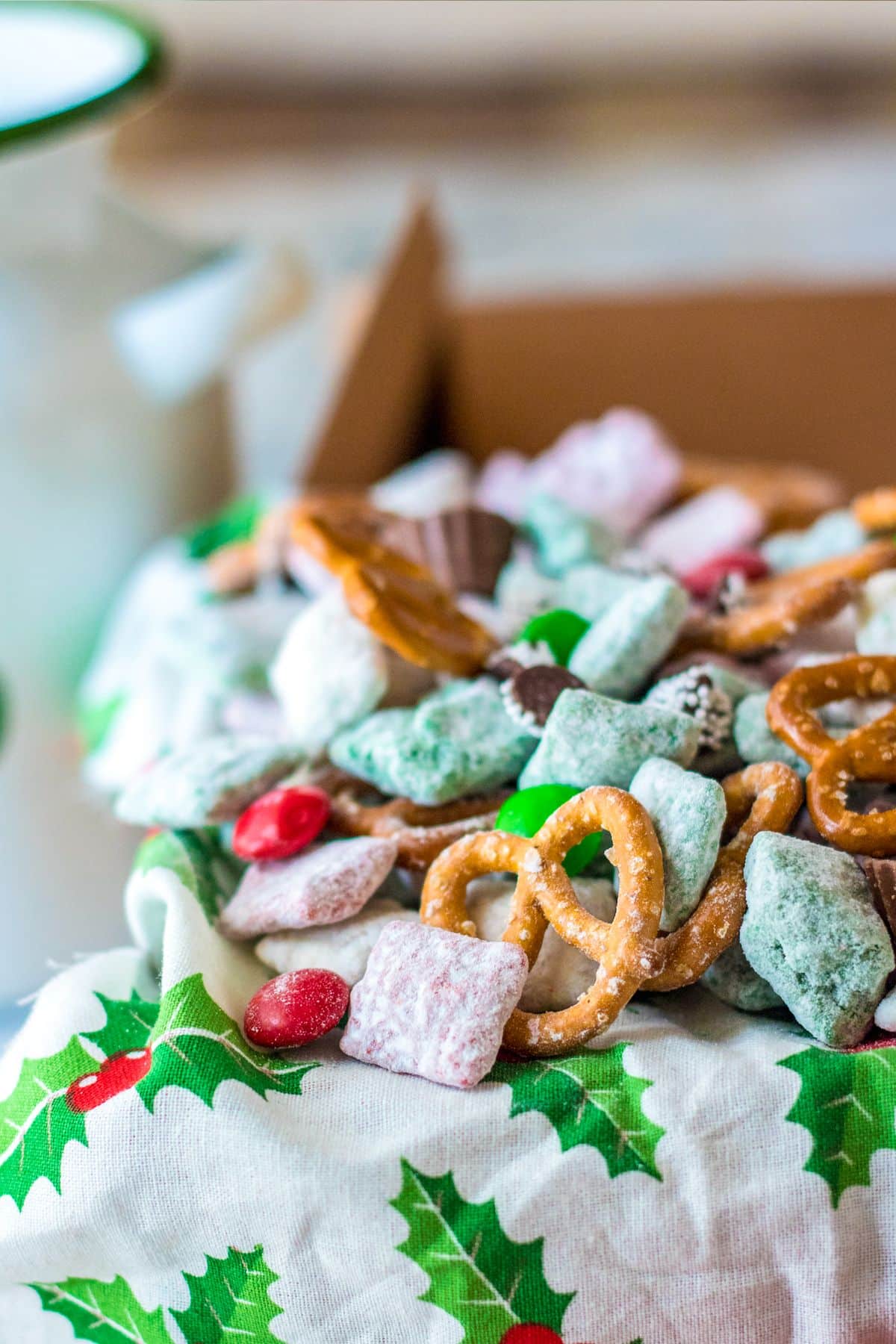 Up close image of Christmas Chocolate Chex Mix served on a Christmas themed cloth.