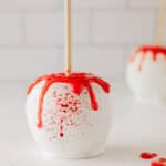 Halloween apple covered in white chocolate and blood splatters.