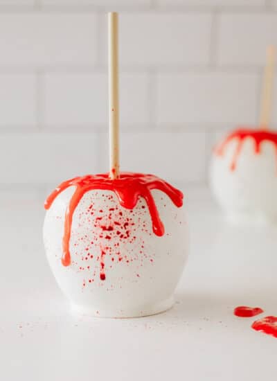 Halloween apple covered in white chocolate and blood splatters.