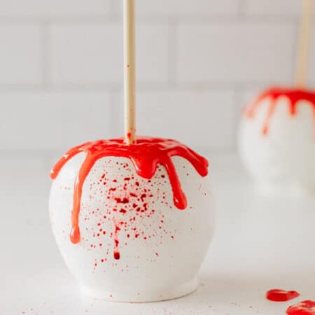 Halloween apple covered in white chocolate and blood splatters.