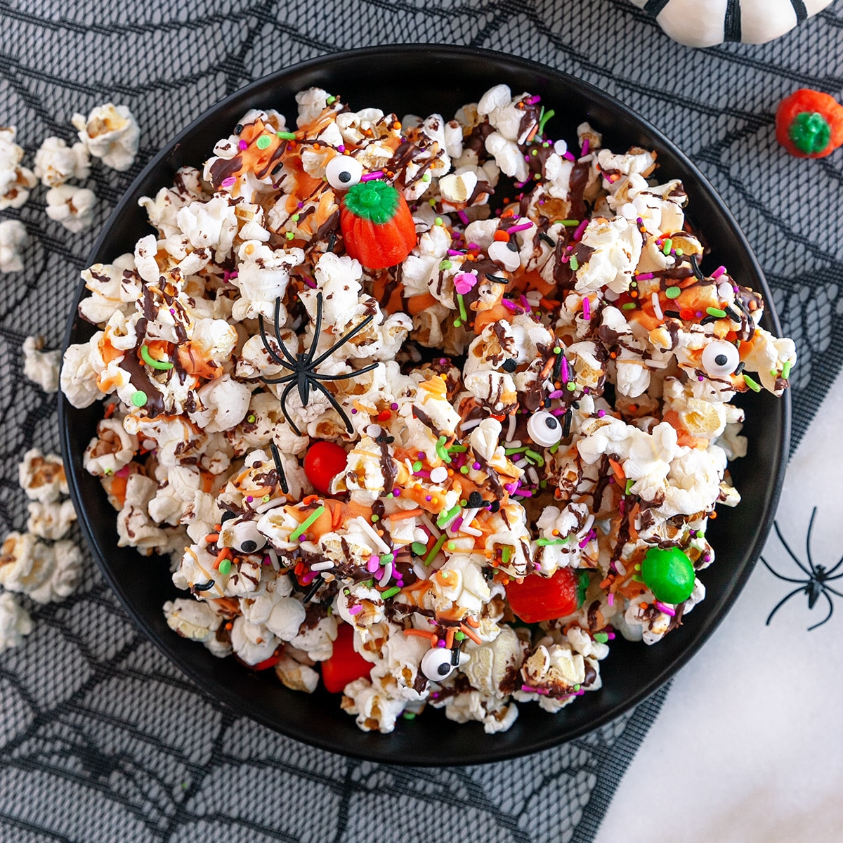 Square photo of Halloween popcorn in a bowl shot from overhead. 