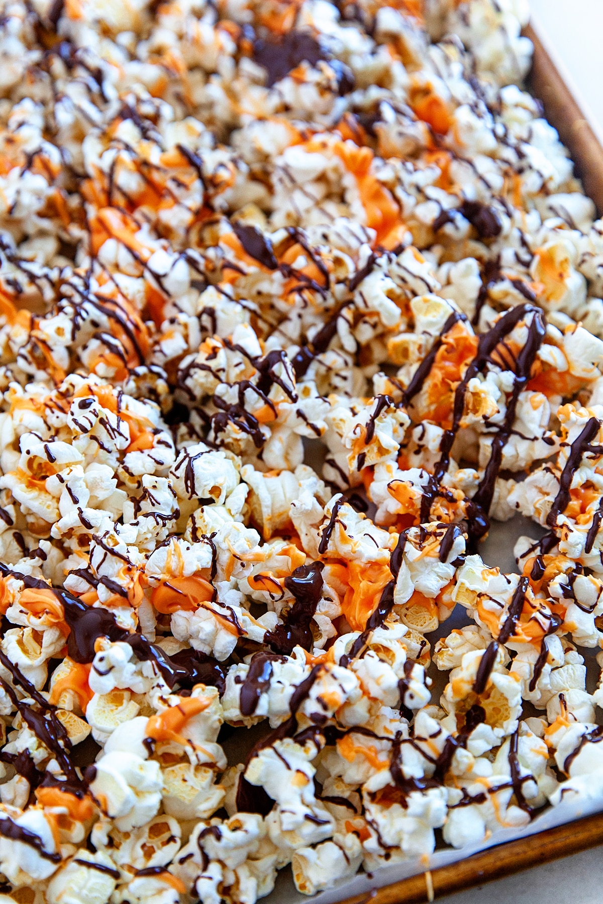 Popcorn drizzled with both orange and dark chocolate. 