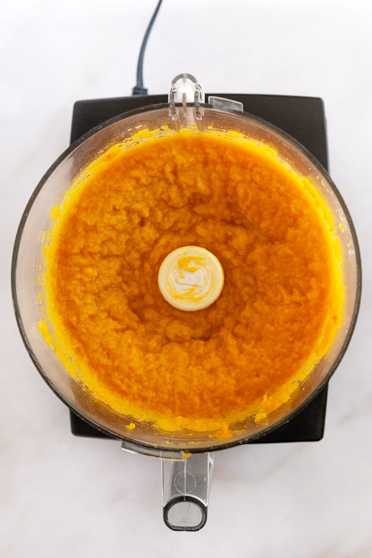 Pureeing pumpkin in a food processor. 