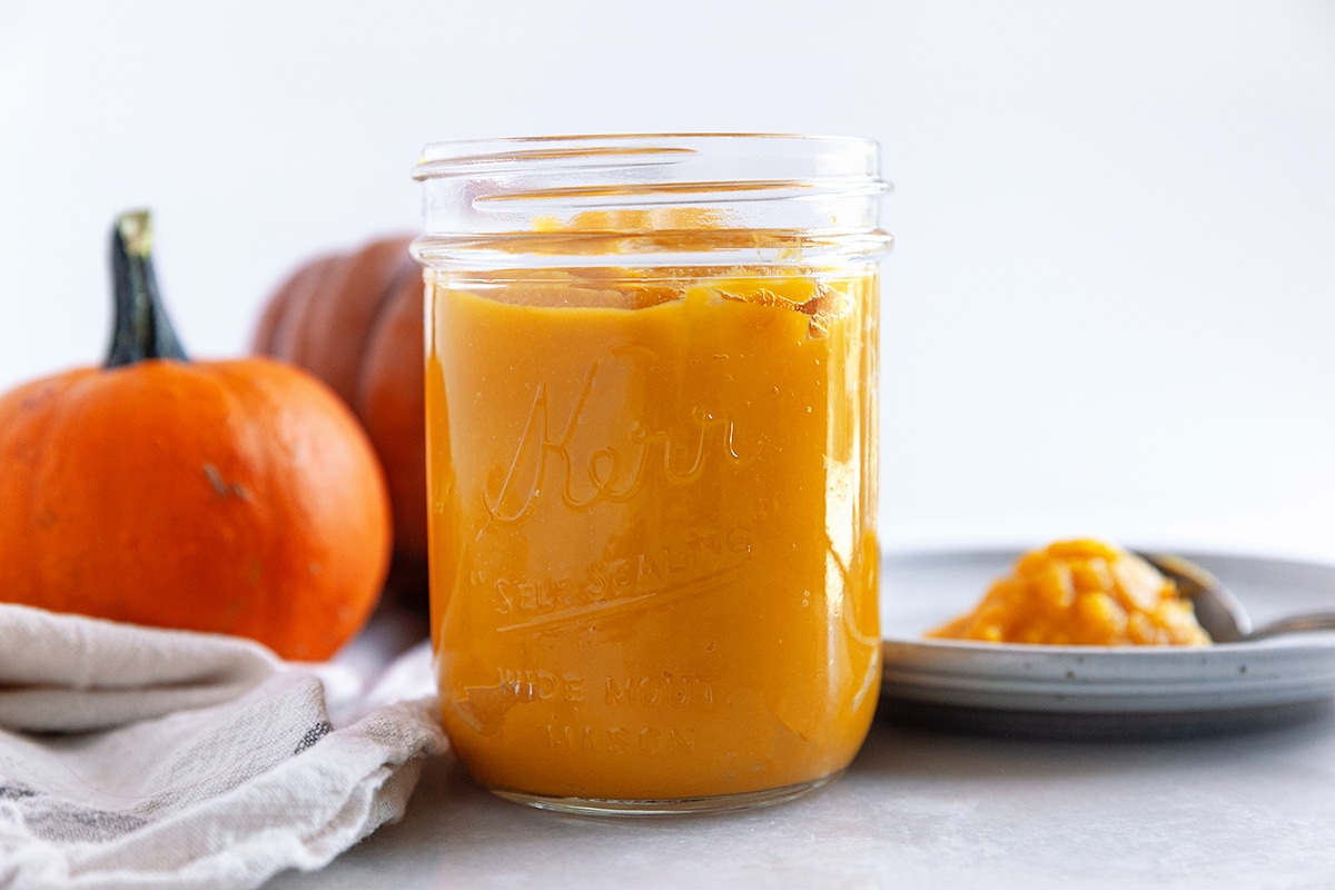 Horizontal photo of pureed pumpkin in a jar, front view. 