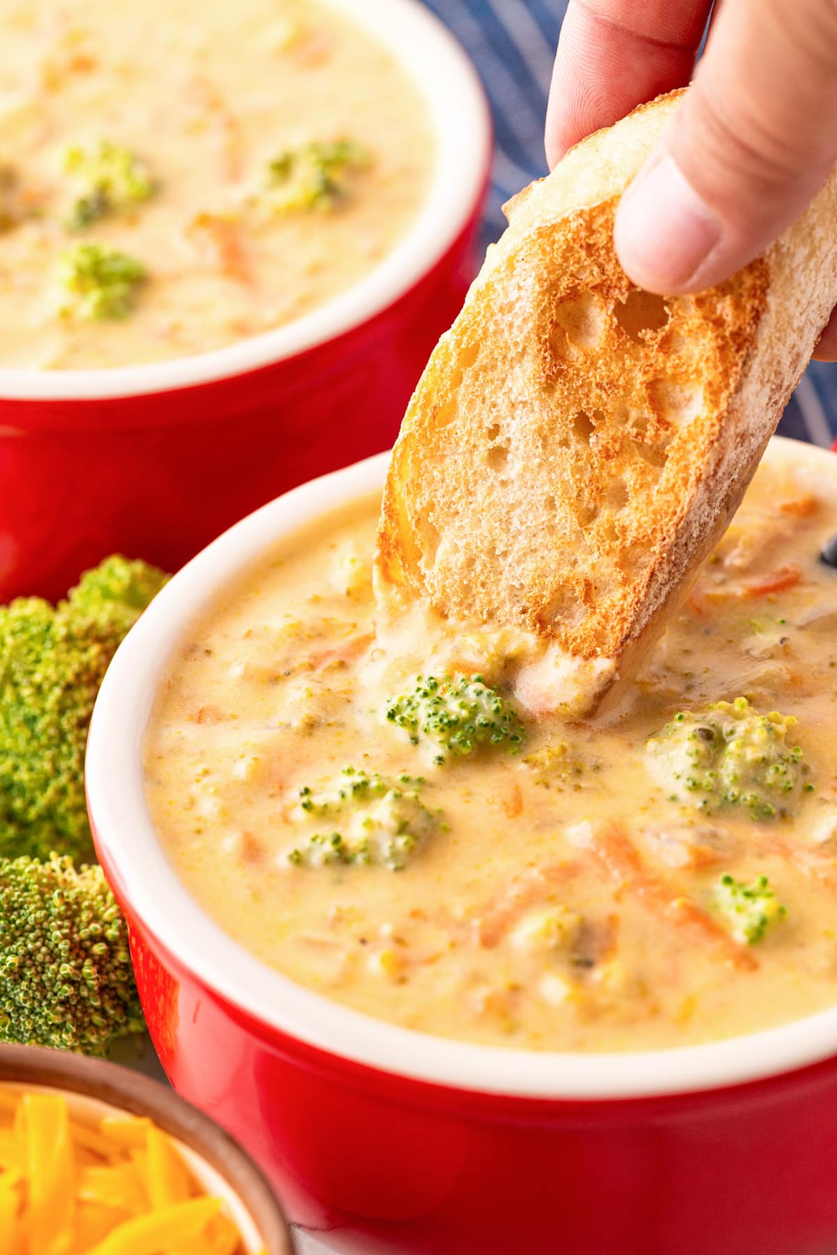 Dipping toast into a bowl of broccoli cheese soup. 