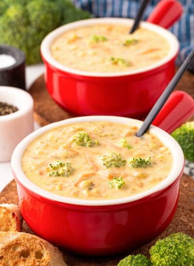 Red bowls of Instant Pot Broccoli Cheese Soup