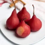 Red Wine Poached Pears on a white plate.