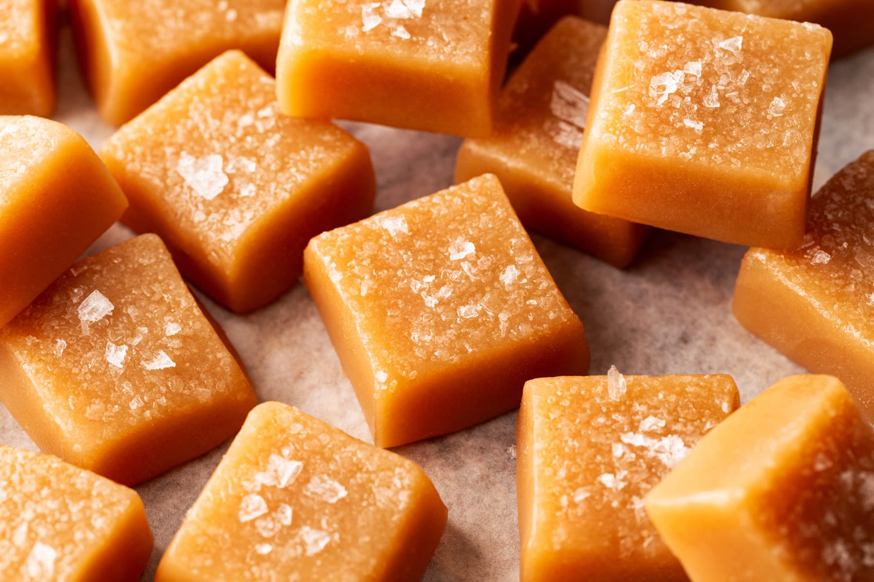 Horizontal picture of squares of salted caramel, some stacked on each other. 