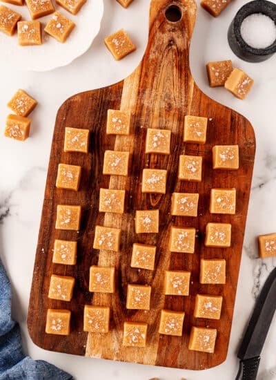 Individual caramels on a board.