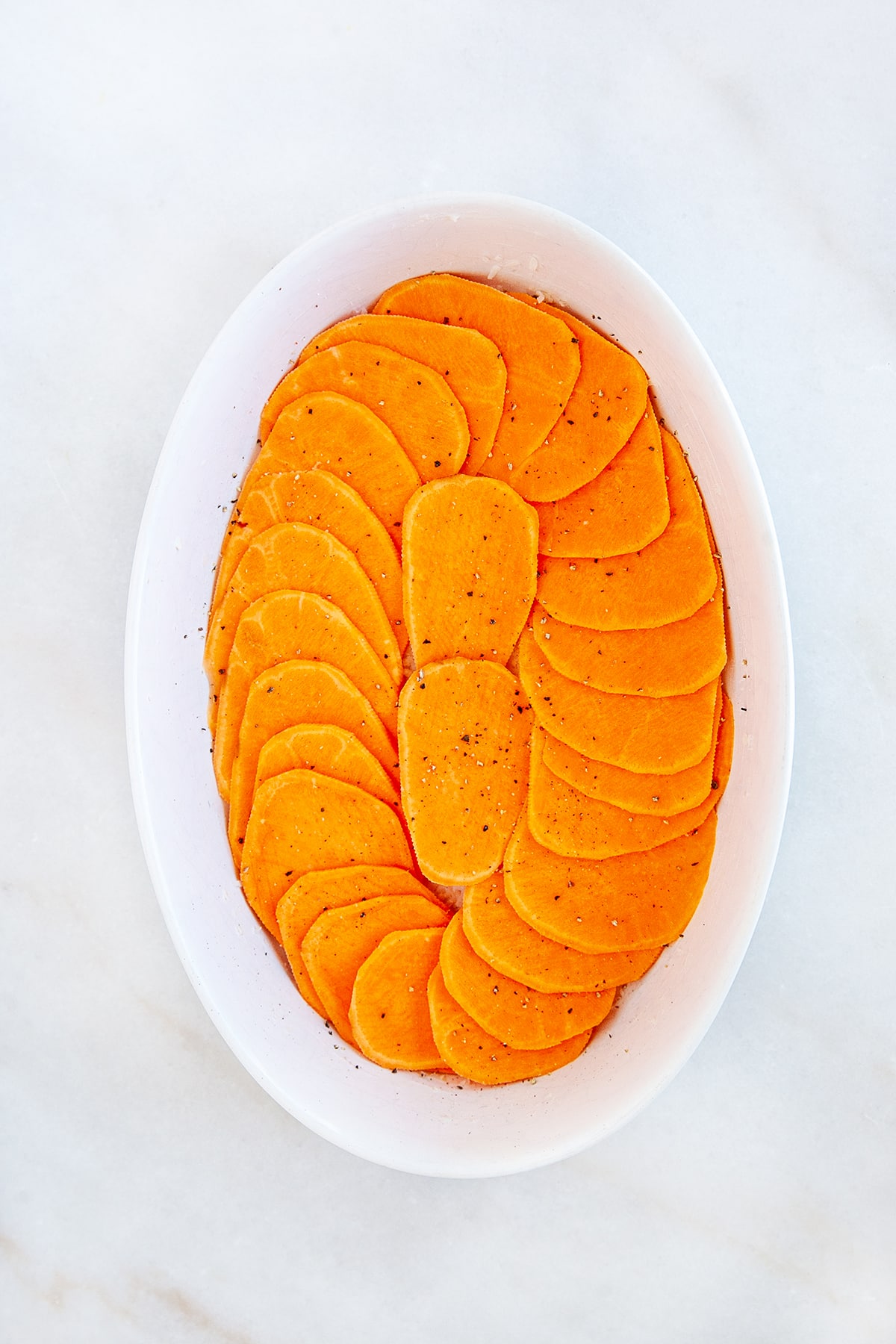Slices of sweet potato in a casserole. 