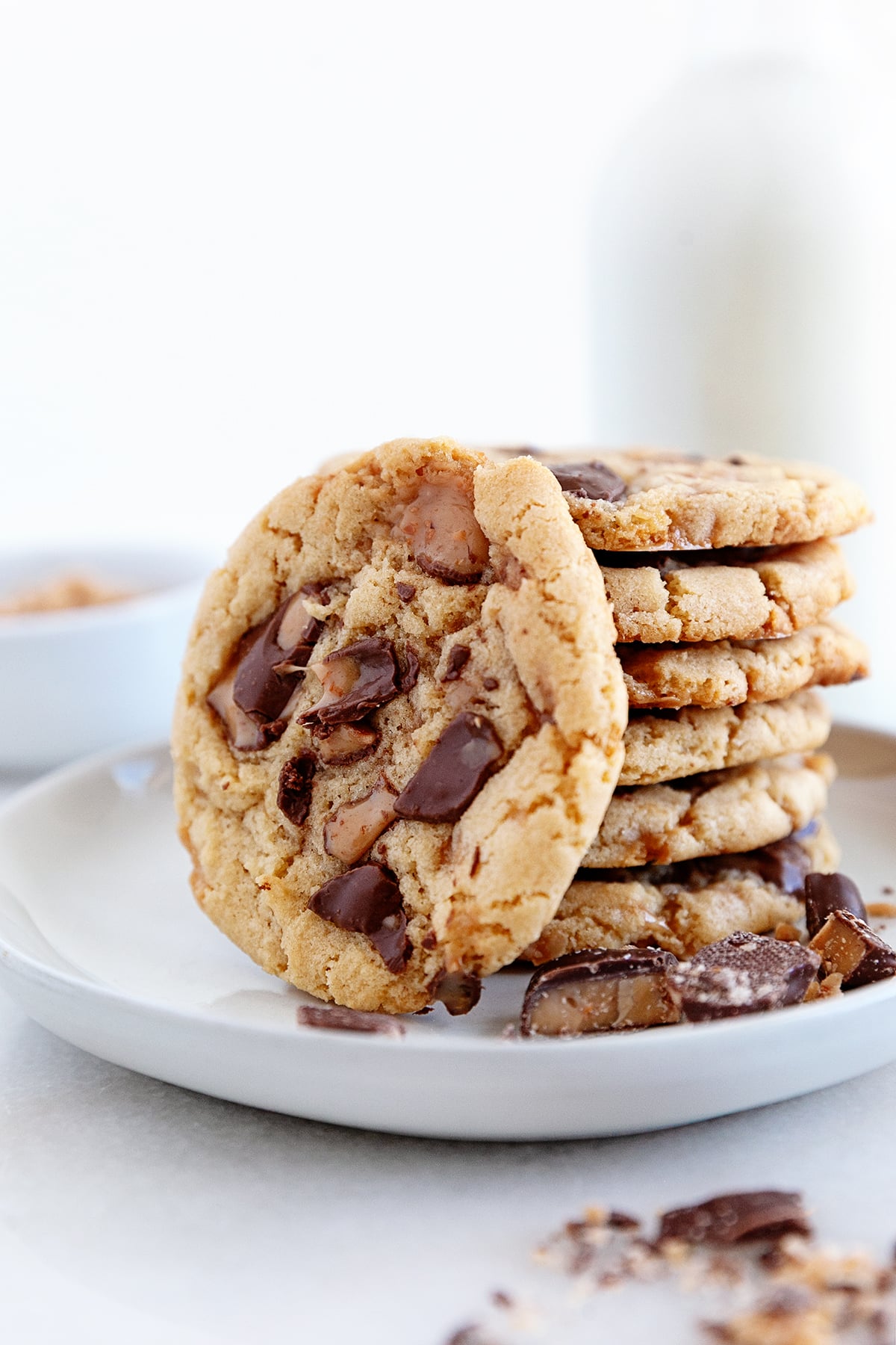 A cookie leaning on a stack of cookies. 