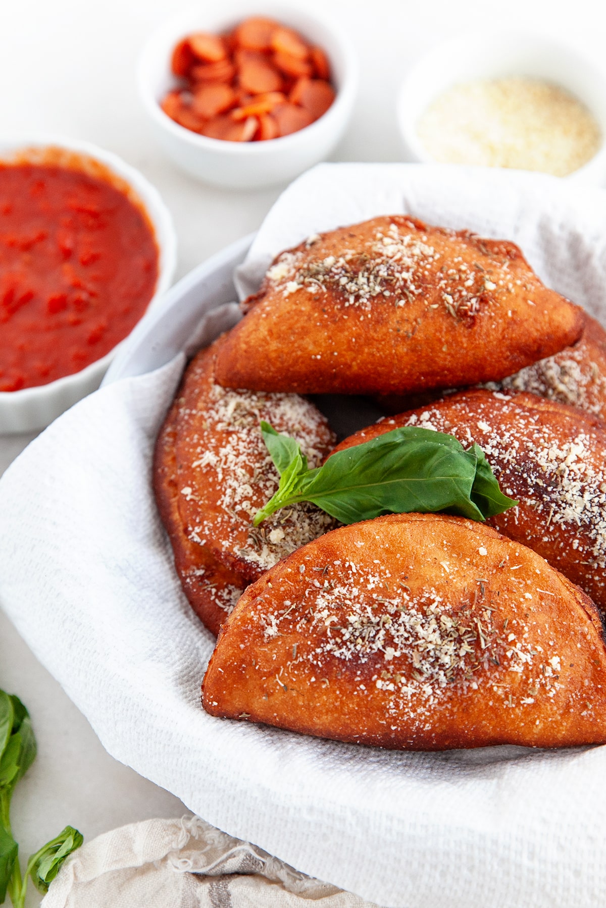 Deep-fried golden brown panzerotti with herbs and Parmesan sprinkled on top. 