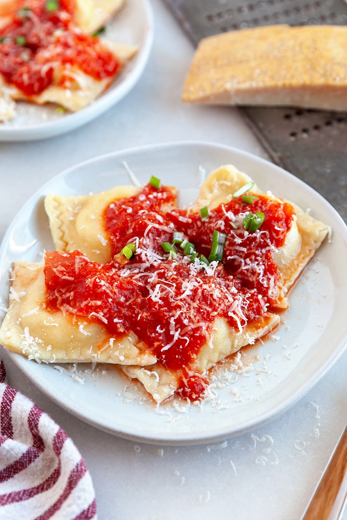 Cheese Ravioli with Red Pepper Tomato Sauce and Parmesan on a plate. 