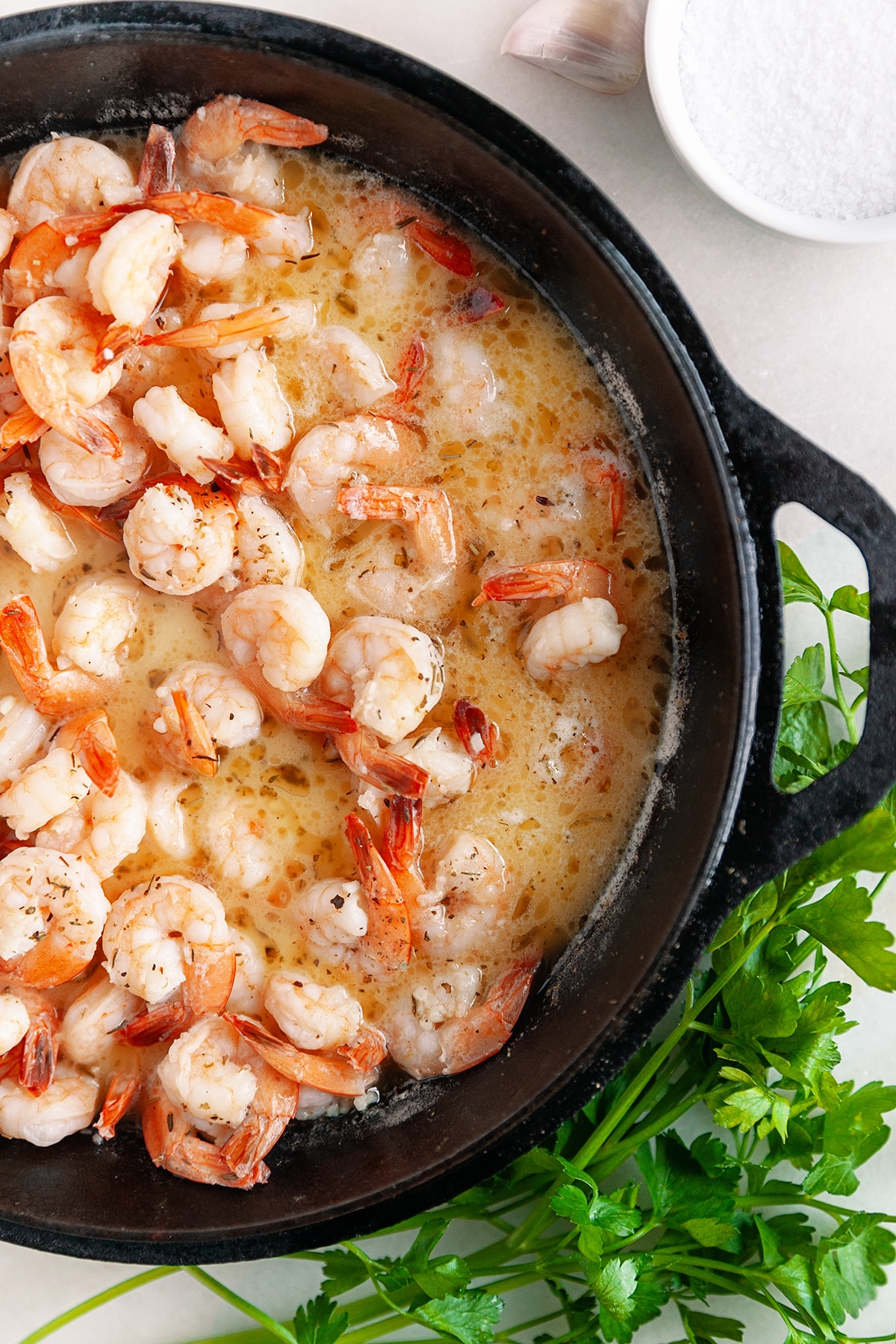 Shrimp in sauce in a cast iron pan. 