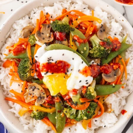 Overhead shot of a poached egg on a Vegetarian Stir-Fry.