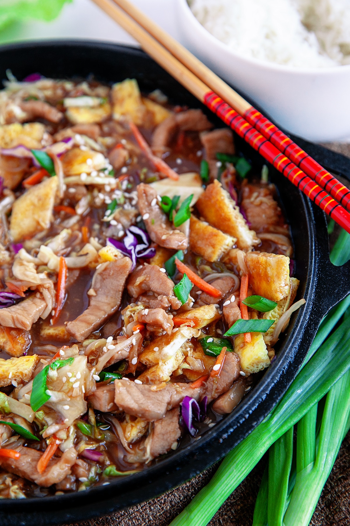  Close-up of moo shu pork in a cast iron pan. 