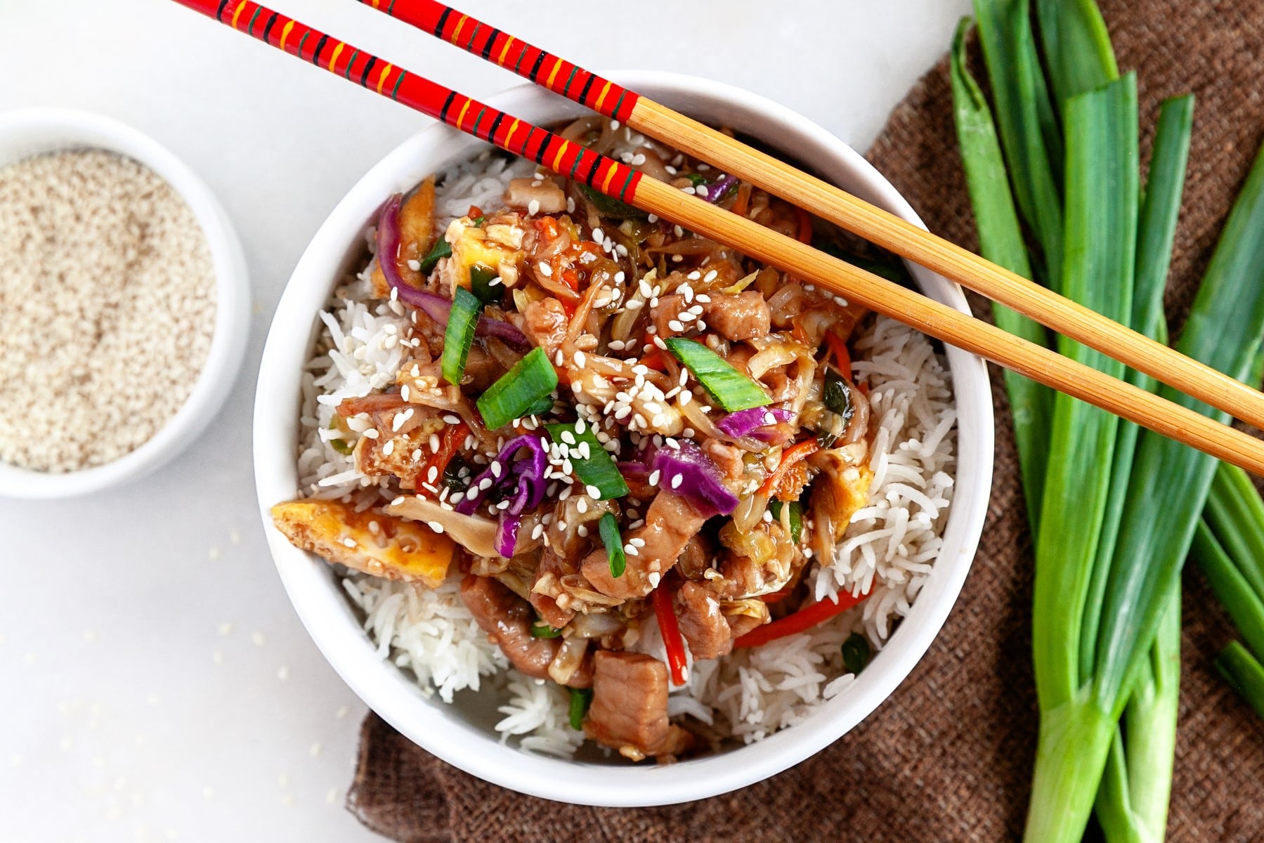 Horizontal picture of moo shu pork on rice in a bowl. 