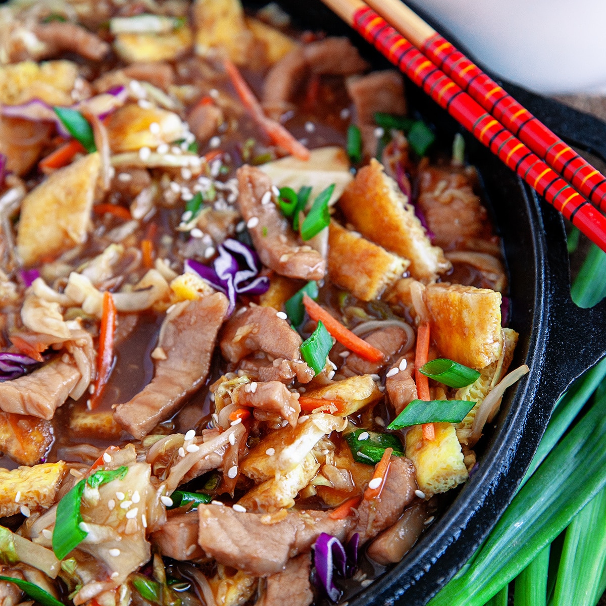  Close-up of moo shu pork in a cast iron pan.