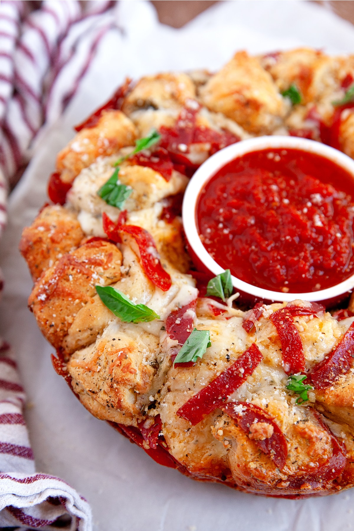Close-up of Pizza Monkey Bread with a dish of marinara in the center. 