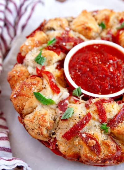 Close-up of Pizza Monkey Bread with a dish of marinara in the center.
