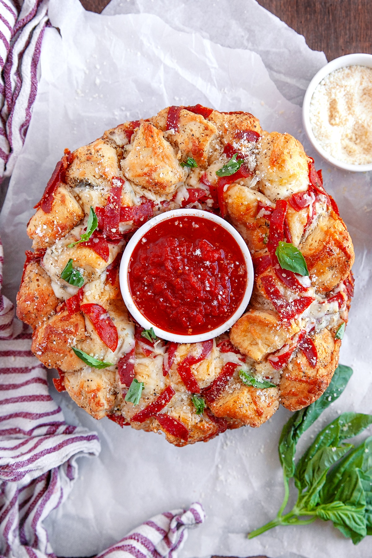 Overhead shot of Pizza Monkey Bread with marinara sauce in the middle. 