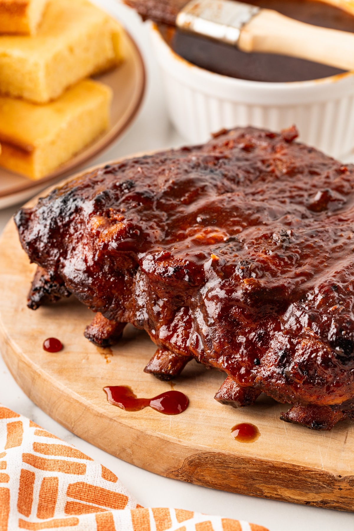 Rack of ribs looking succulent and dripping with BBQ sauce. 