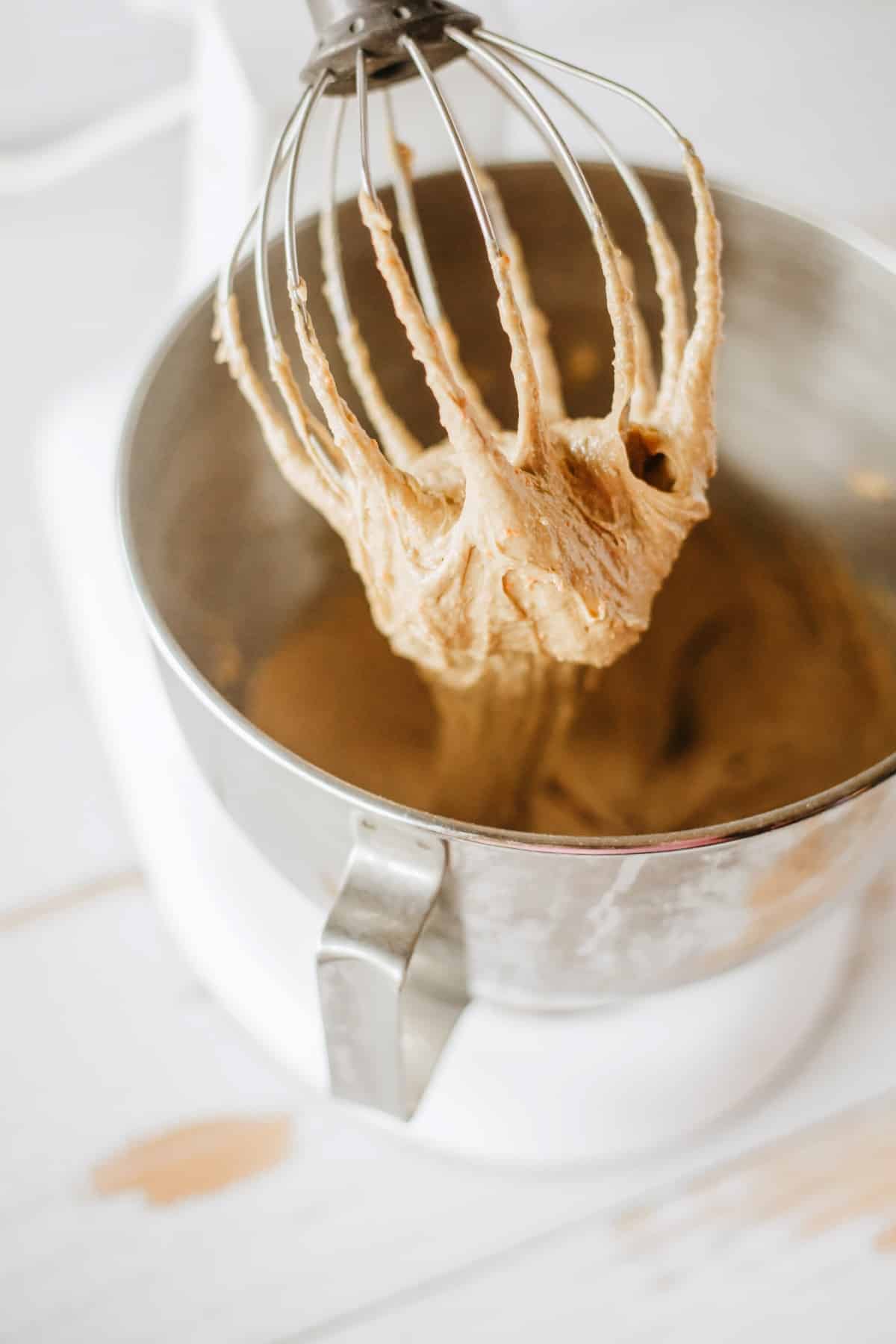 Pulling the whisk up from the batter. 
