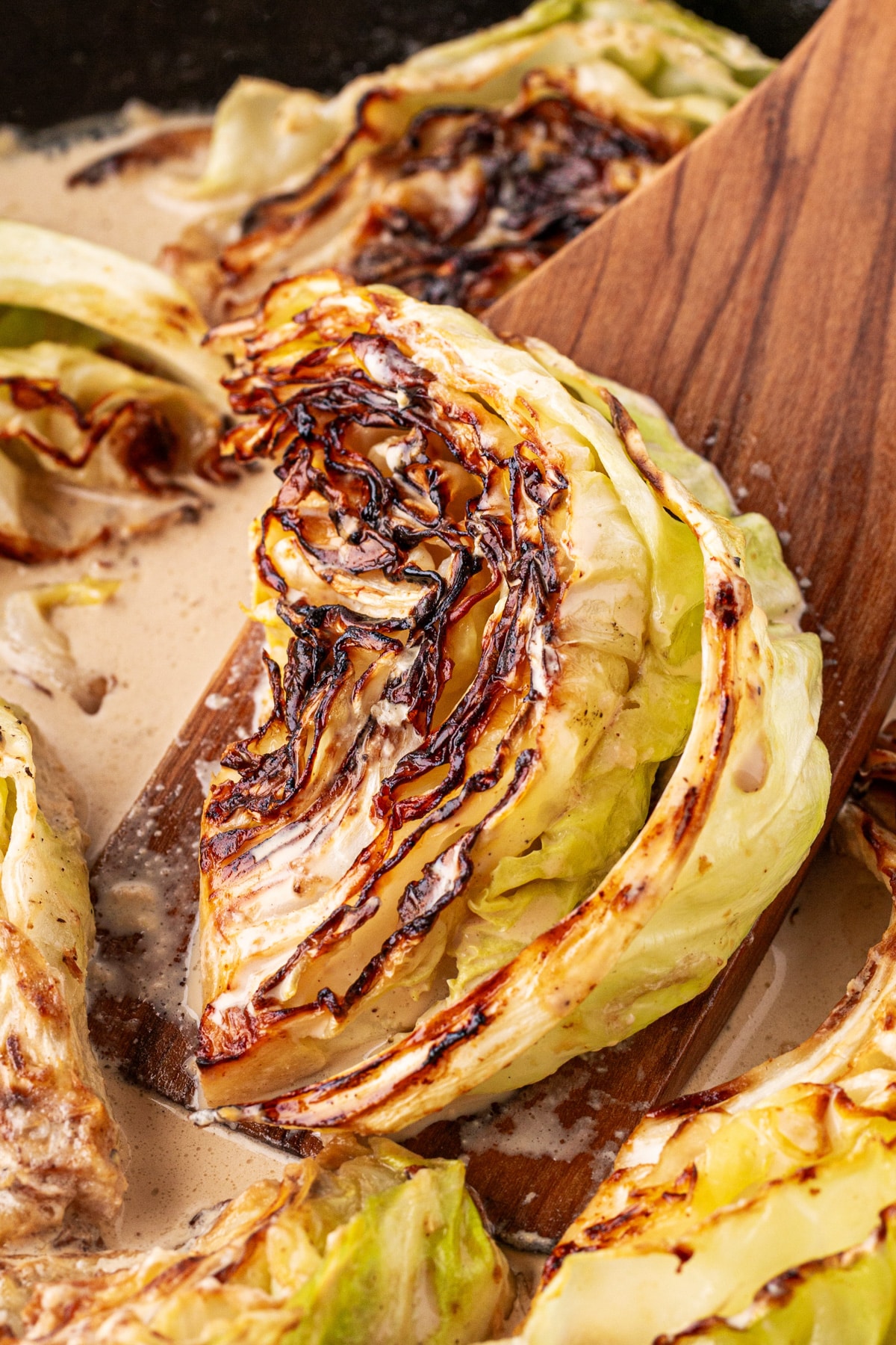 Lovely charred wedge of cabbage on a spatula. 