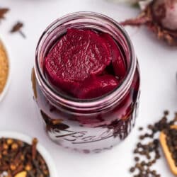 Looking inside a jar of pickled beets.