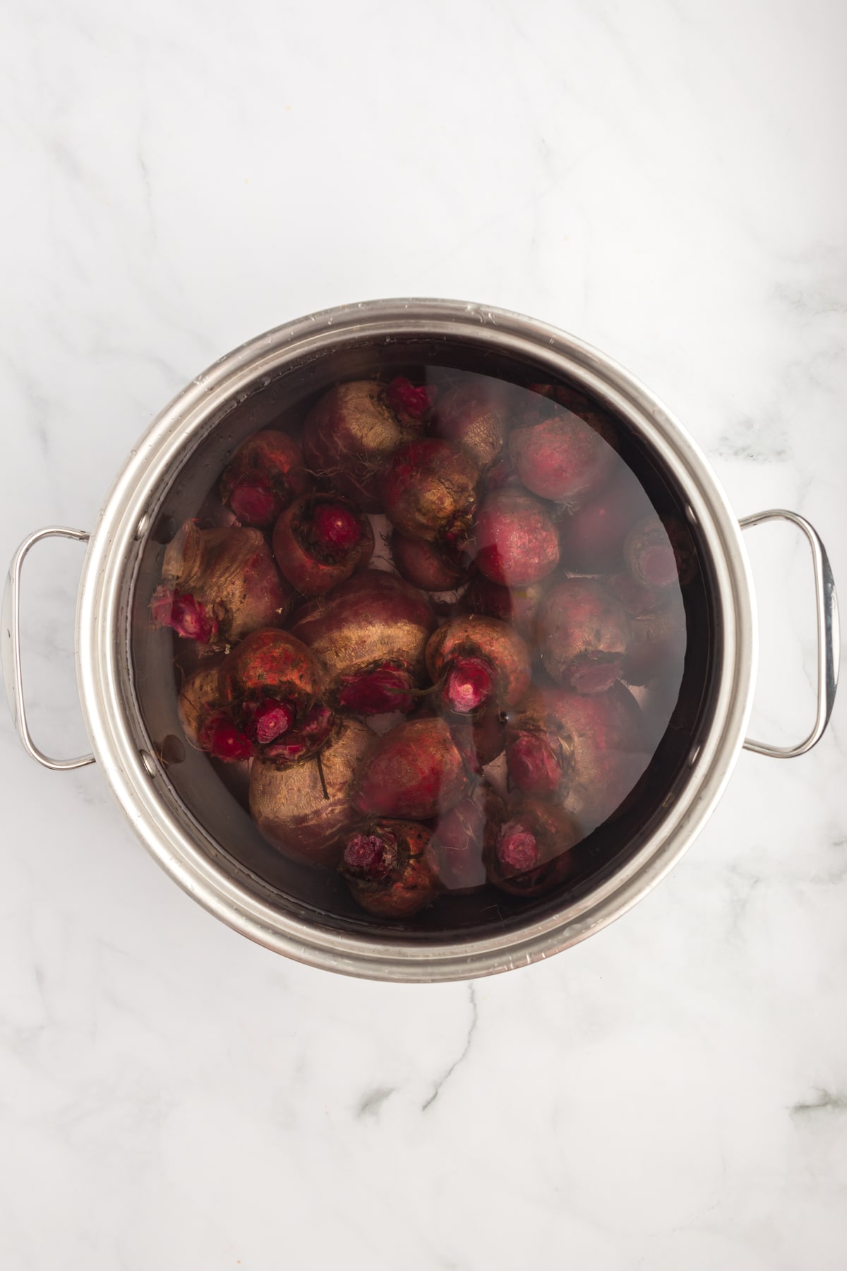 Whole beets in a pot of water. 