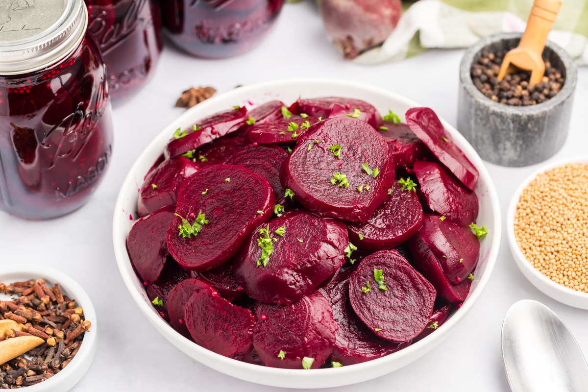 Horizontal picture of sliced pickled beets in a bowl. 
