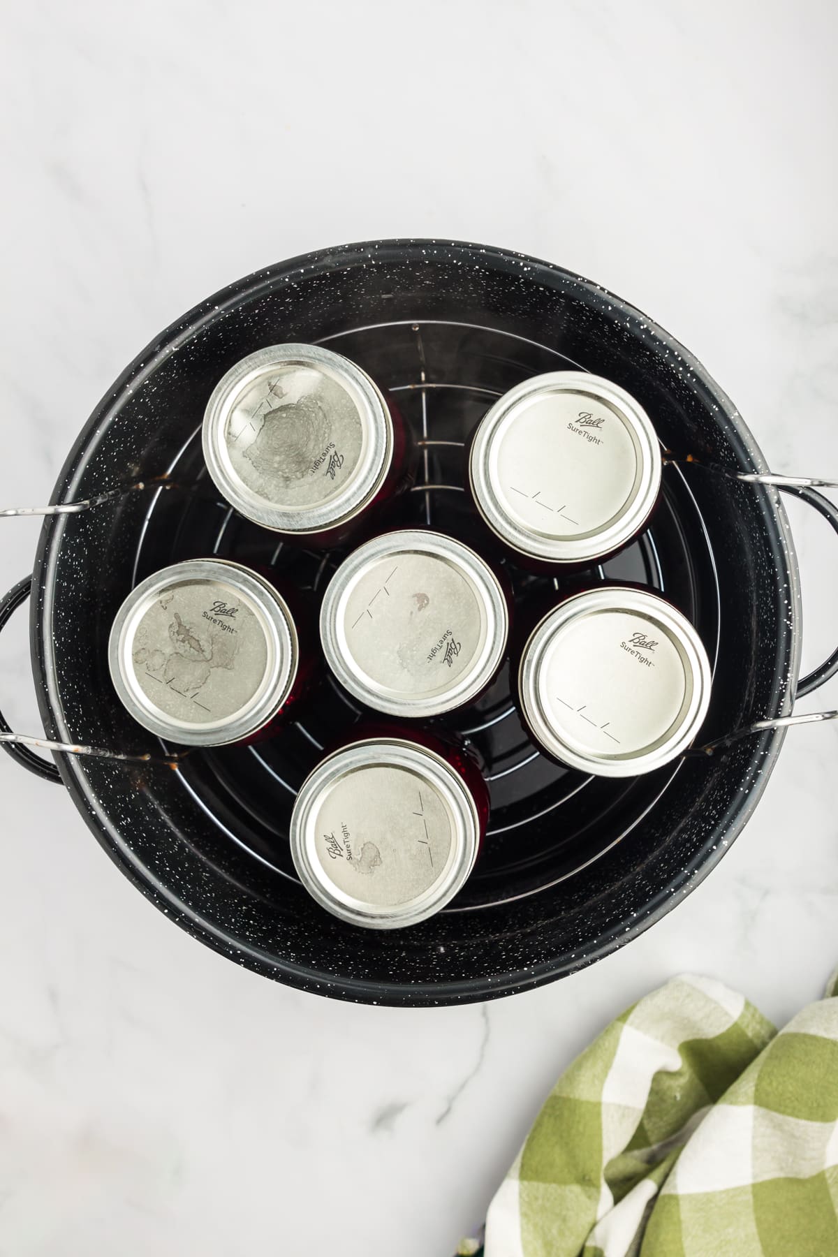 Overhead shot of jars in a canner. 