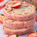 Stacked slices of pound cake with a half strawberry on top.