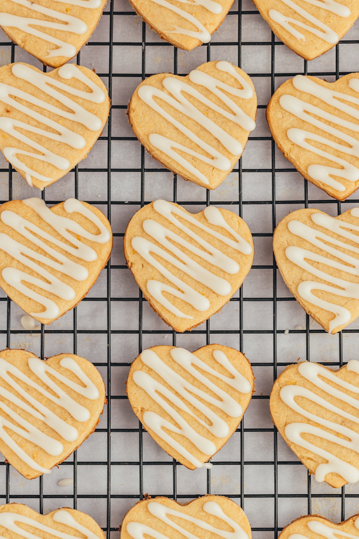 Drizzled cookies on a cooling rack. 