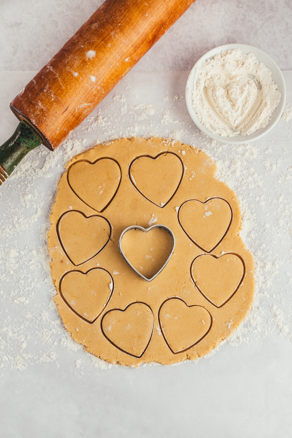 Using a heart shaped cutter to cut out cookies. 