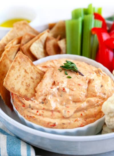 Dip platter with one cracker in the dip.