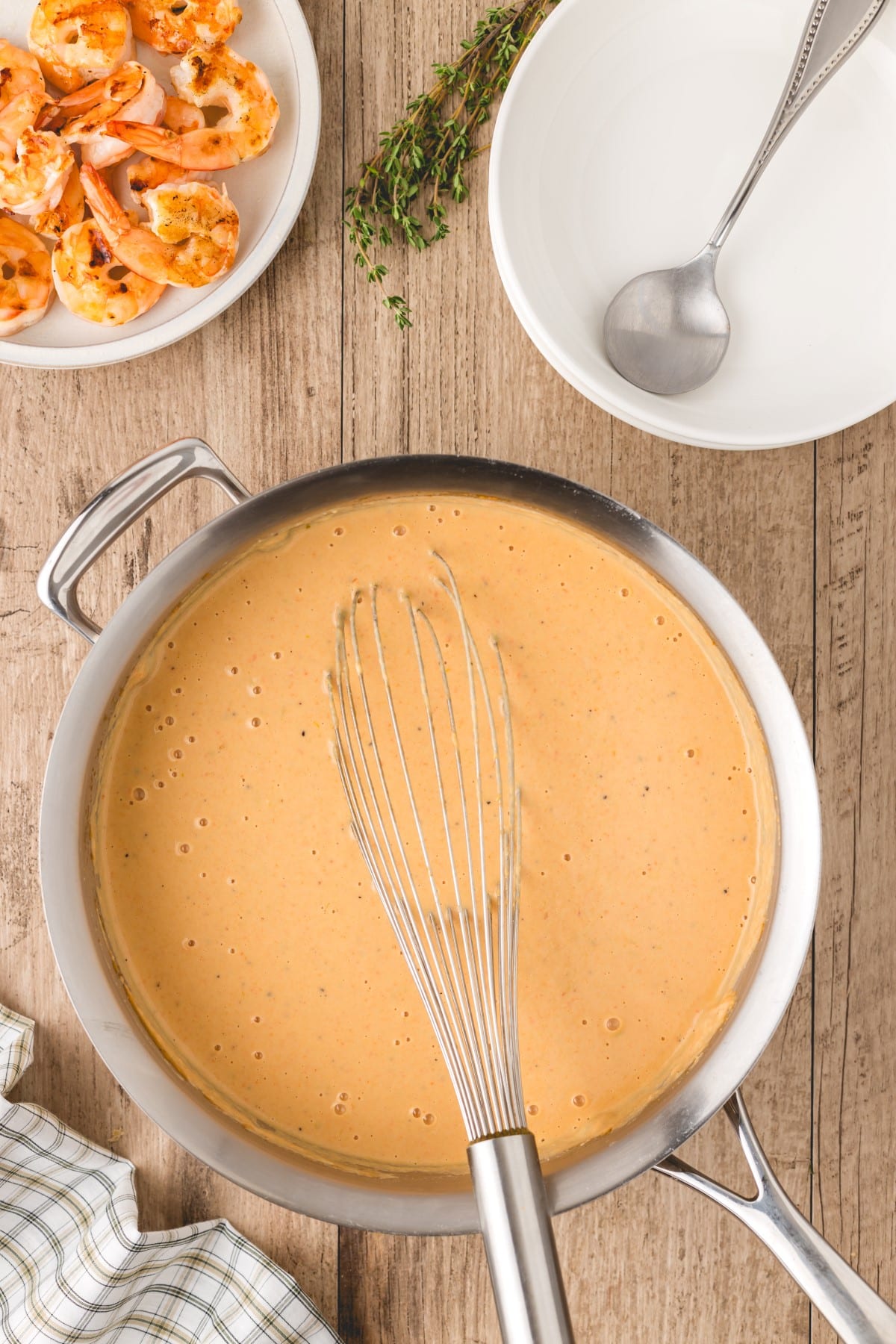 Soup in a pot with a whisk. 