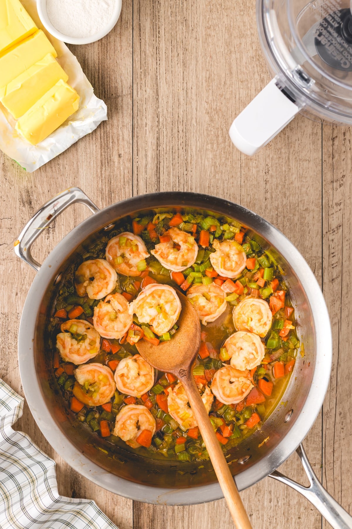 Cooking veggies and shrimp in a pot. 