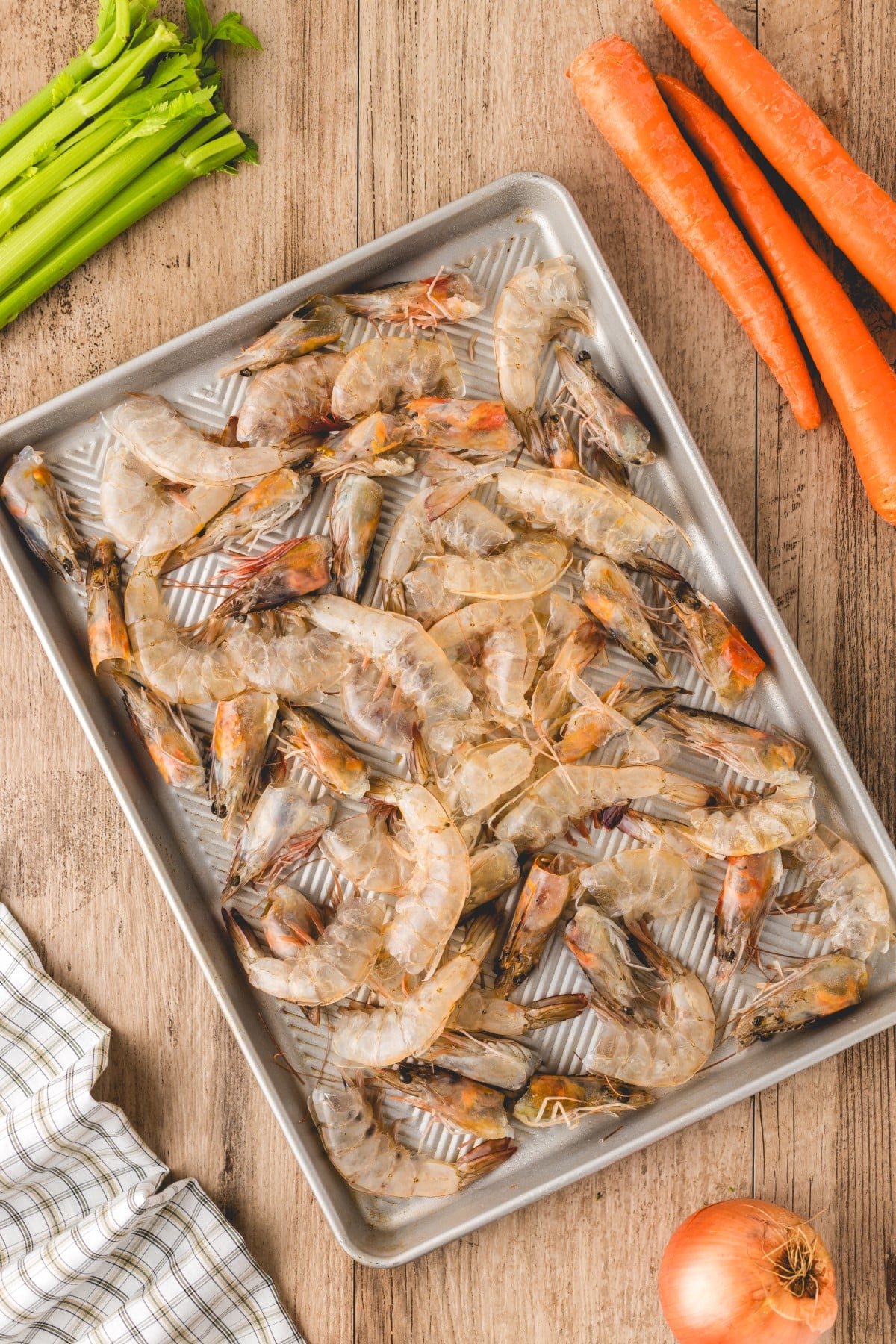 Shrimp shells and heads on a baking sheet. 