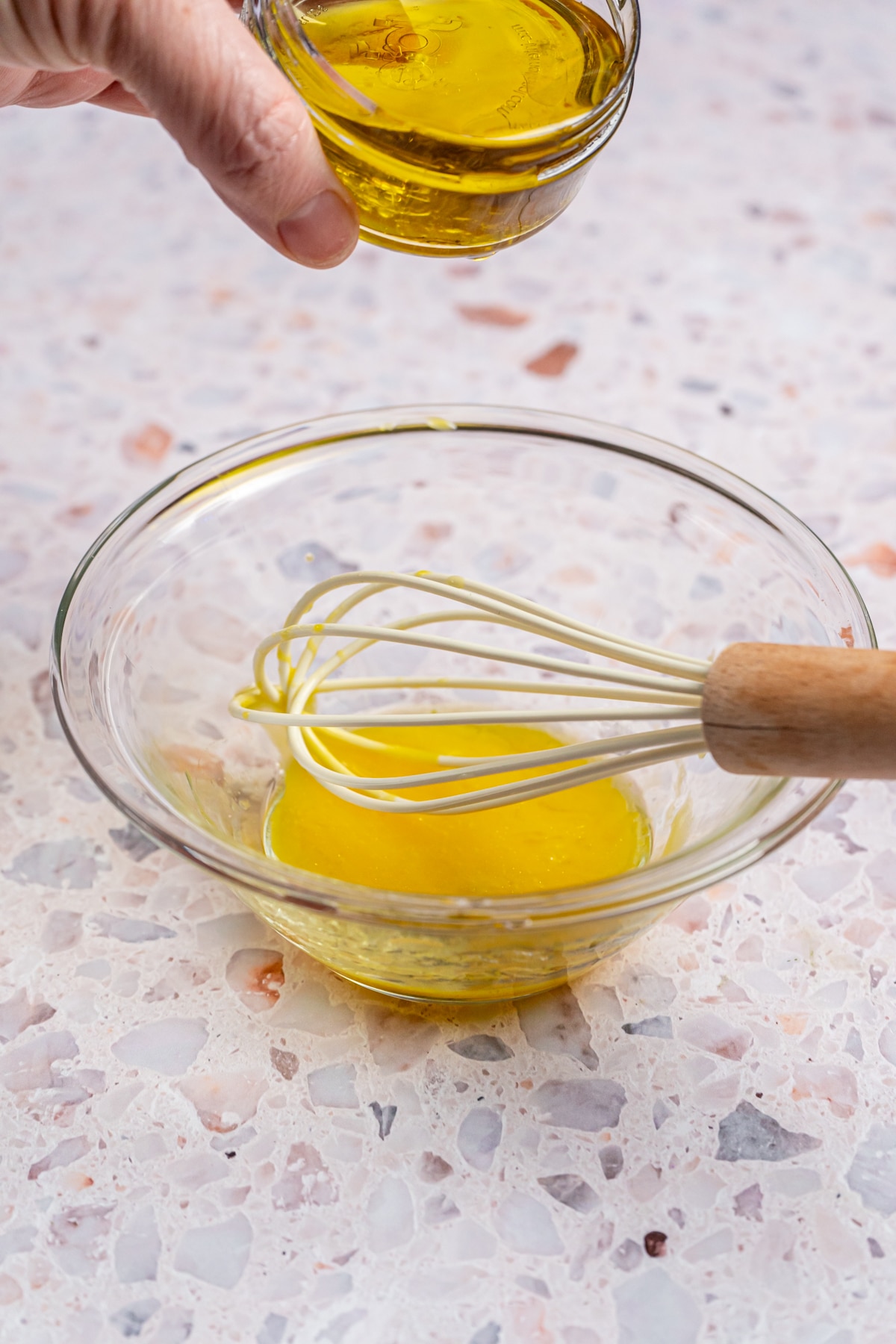 Adding oil to egg. 