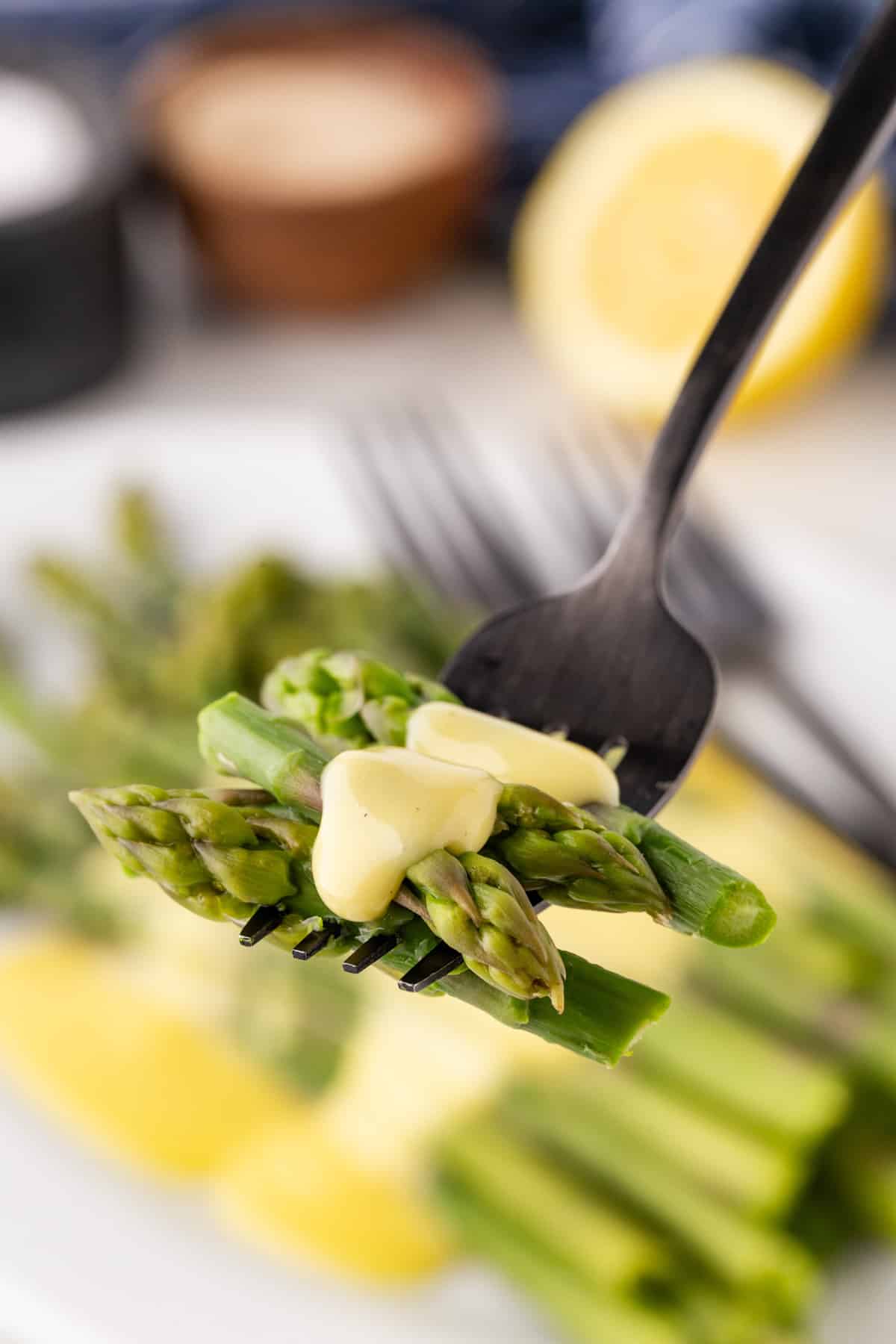 Asparagus with Hollandaise Sauce on a Fork. 