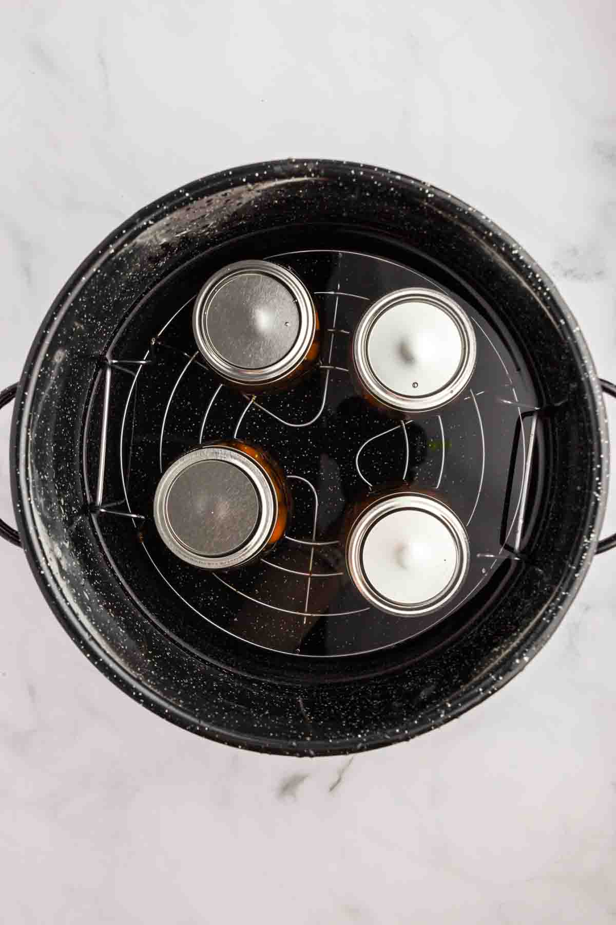 Overhead shot of jars in a canner. 