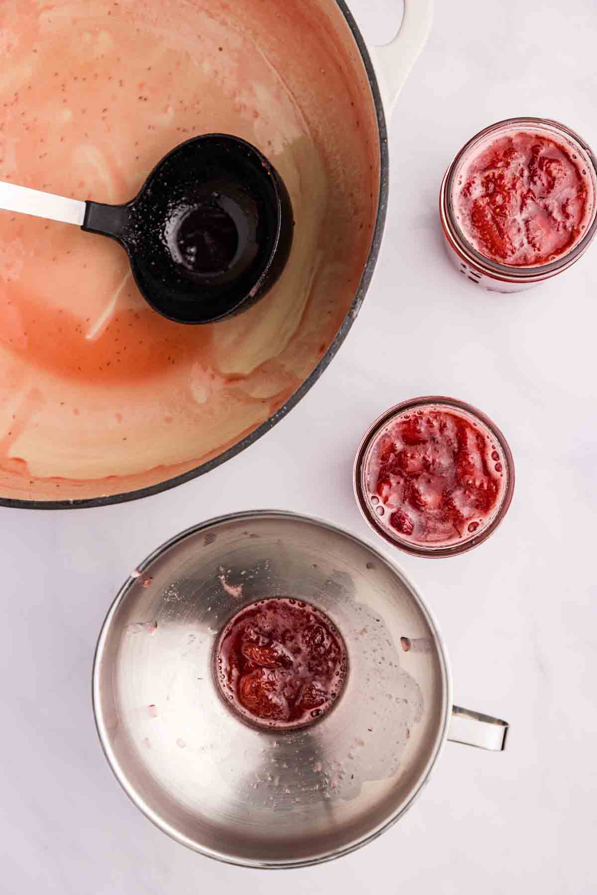 Using a funnel to pour the jam into jars. 