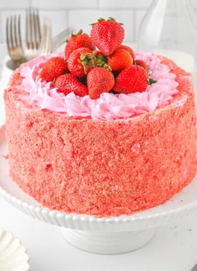 Strawberry Crunch Cake on a cake stand.