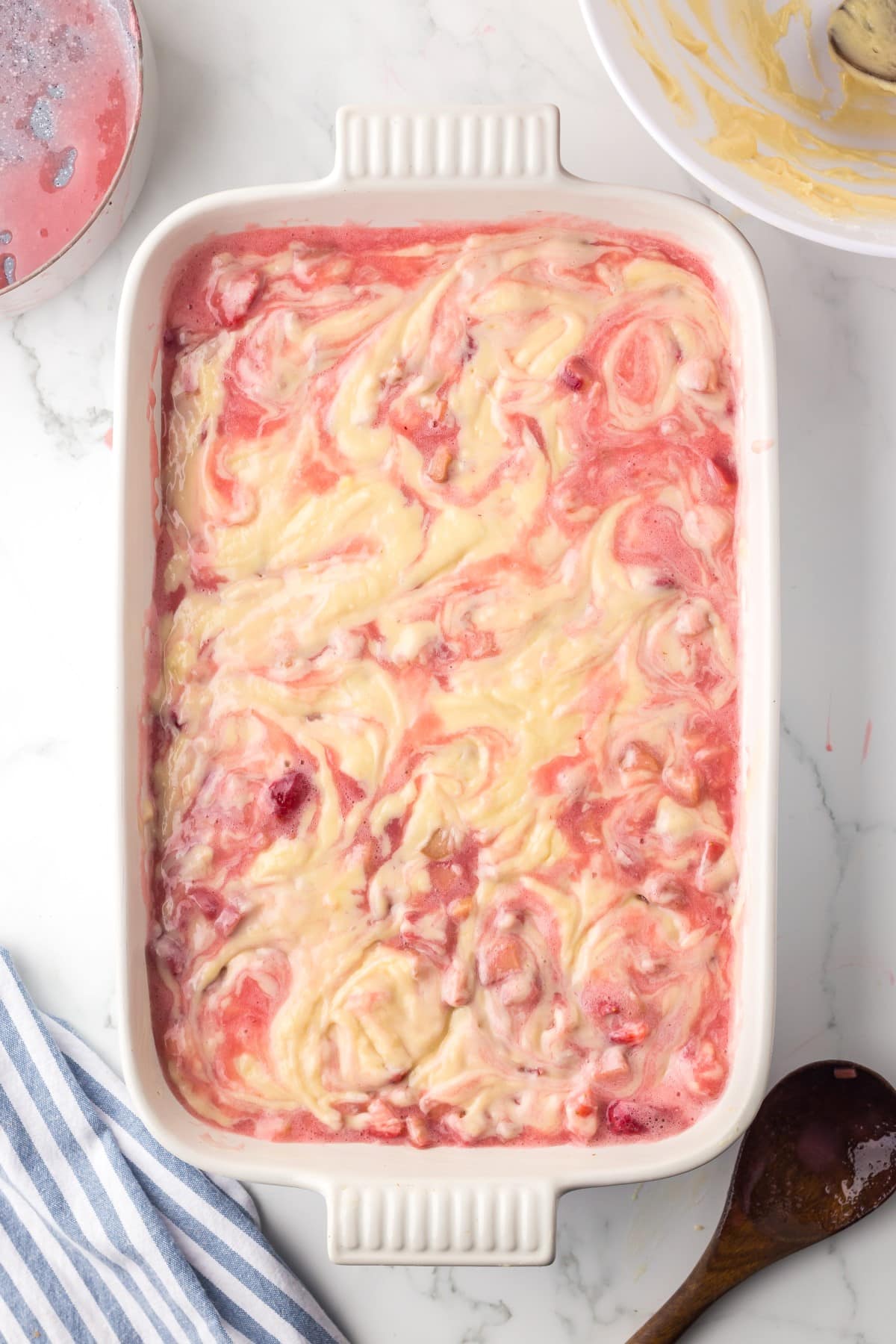 Rhubarb and strawberry layer added along with final layer of batter and spread and swirled together. 