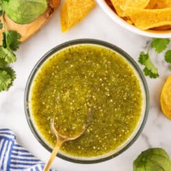 Salsa verde in a bowl with a spoon.