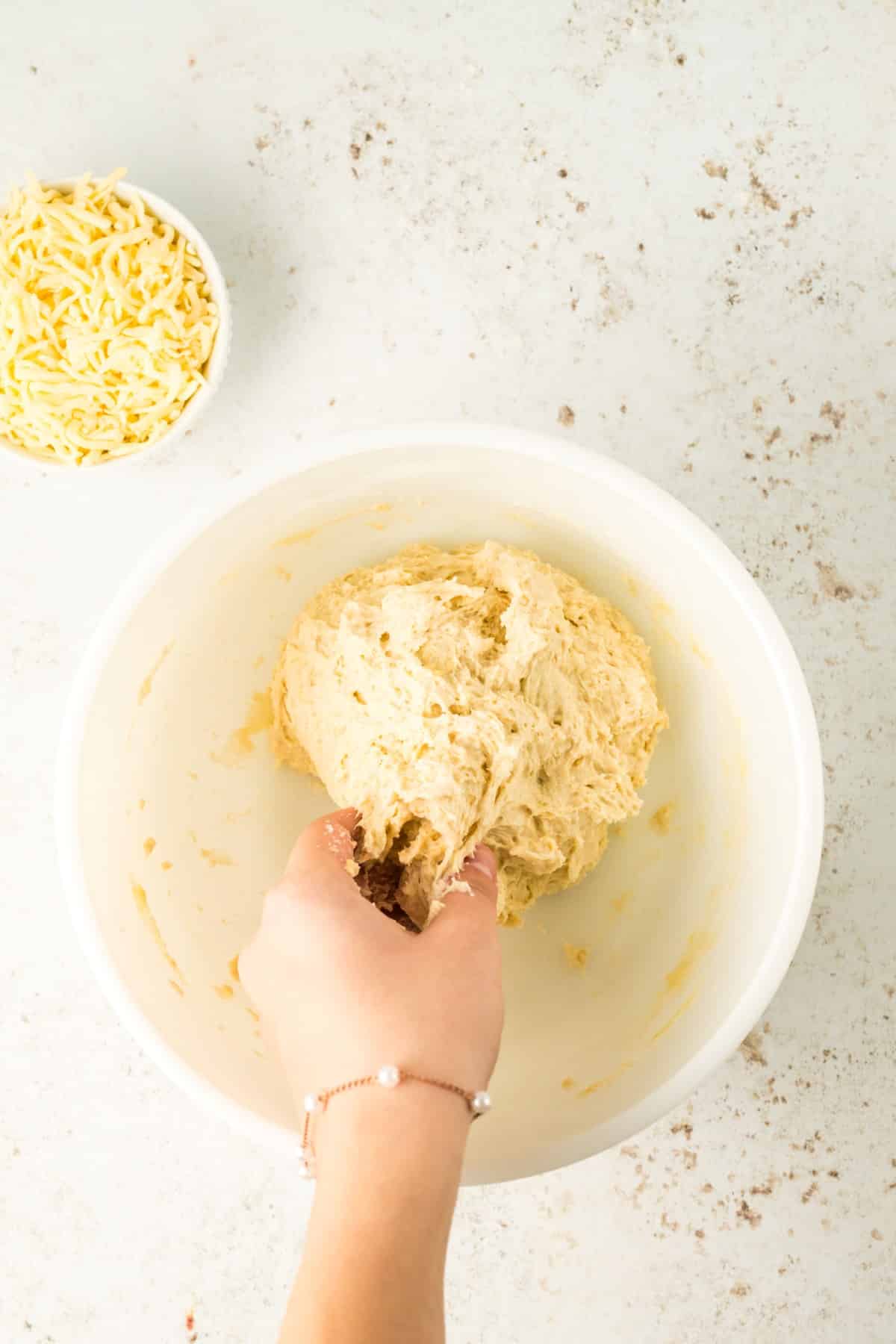 Making dough into a ball in a bowl. 